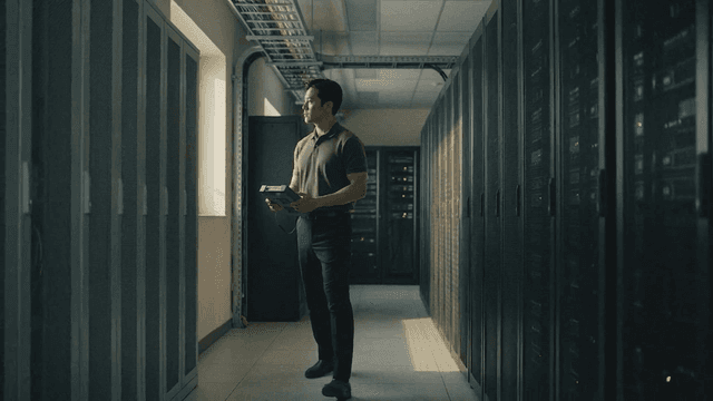 Man inspecting servers at data center