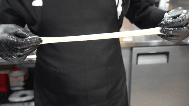 Rice cakes stretched by hand in kitchen