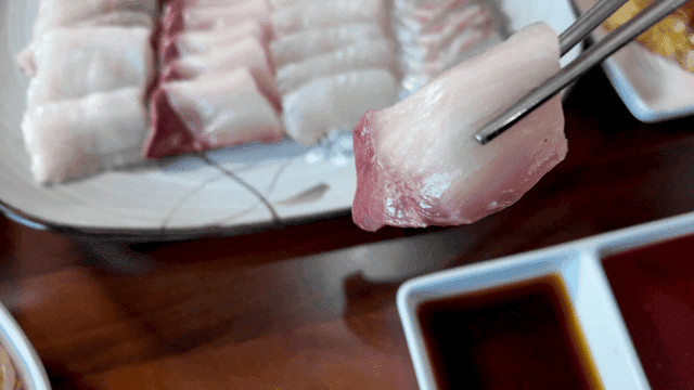 Fresh raw fish dipped in soy sauce