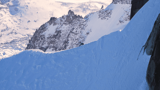 Hikers descending snow-covered mountain