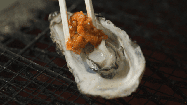 Fresh oysters topped with kimchi