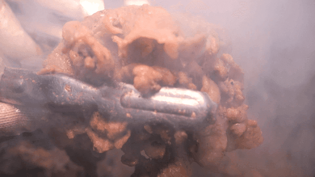 Briquette bulgogi lifted with tongs