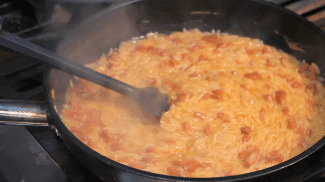 Pasta stirred in steaming pan