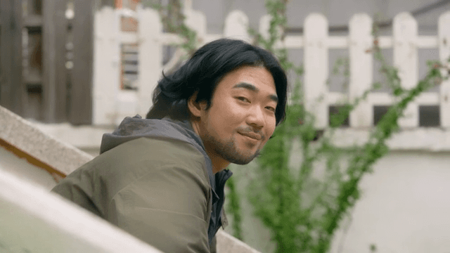 계단에 앉아 바라보며 웃는 남자