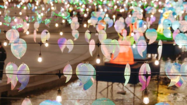 People enjoying the colorful lanterns that light up cheonggyecheon stream