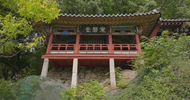 Traditional Korean pavilion surrounded by trees