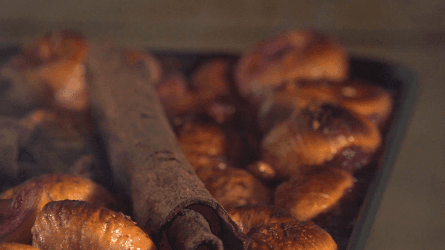 Oven tray with baked figs and cinnamon holding mulled wine
