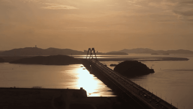 Bridge over a calm sea at sunset