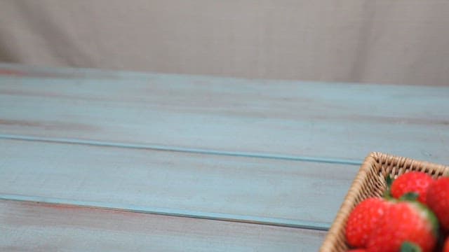 Basket of fresh strawberries on a table