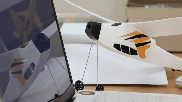 Model airplane next to a laptop
