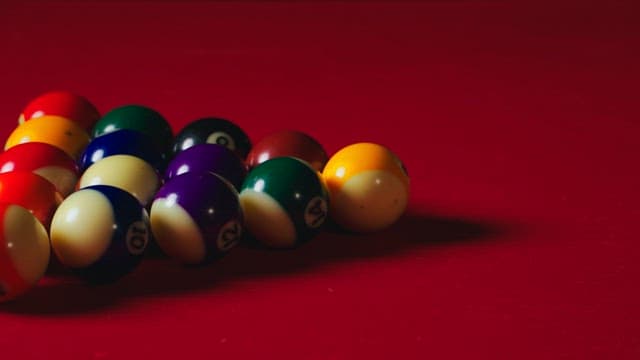 Pool balls lined up on a billiard table