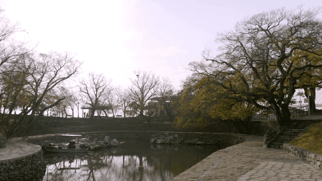 Tranquil lake with boats and trees