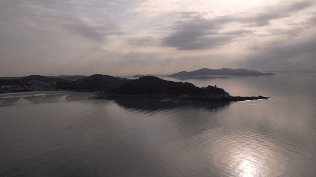 A serene coastal landscape at sunset