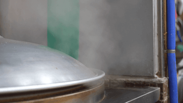 Steam rising from a large cooking pot