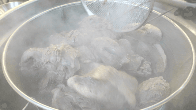 Boiled beef being prepared in a kitchen