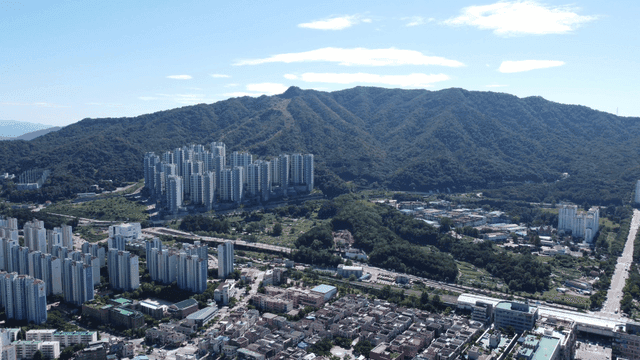 Cityscape with mountains in background.