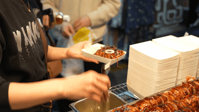 Street vendor preparing rolled pork belly