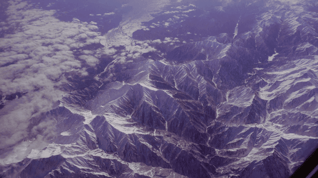 Snow-covered mountains seen from airplane window