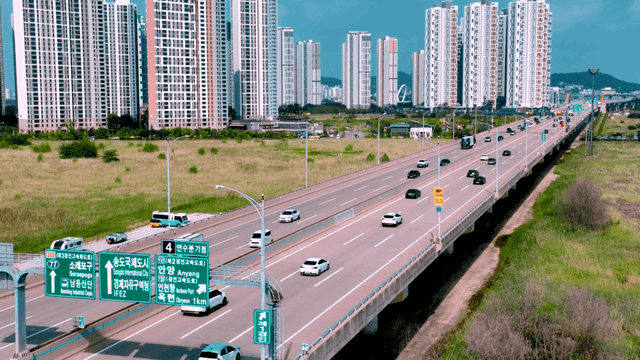 Highway with cars and tall buildings