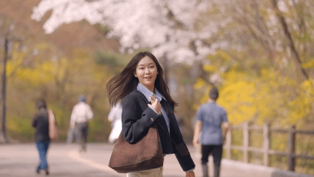 Woman waving to someone while walking
