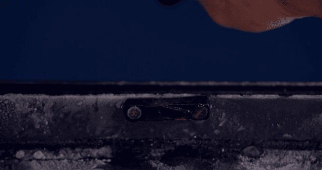 Hand opening and closing the latch of a frosted window