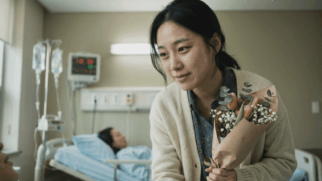 Woman visiting hospital with bouquet of flowers