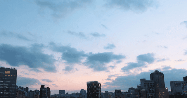 City skyline at dusk with clouds