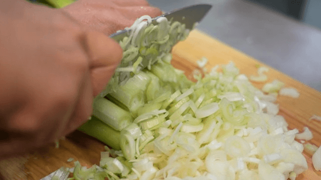 Chopping green onions on a wooden board