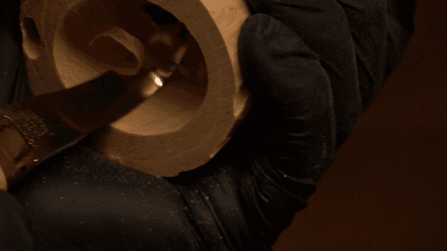 Curved chisel carving a piece of wood