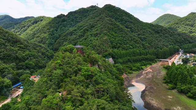 Lush mountain with a traditional pavilion
