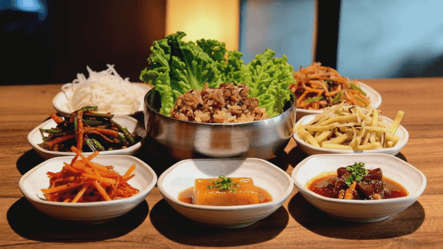 Various bibimbap vegetables and side dishes on table