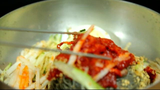 Cold buckwheat noodles with raw pollack picked up with chopsticks