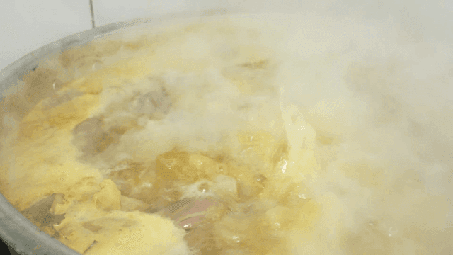 Pot with steaming broth boiling