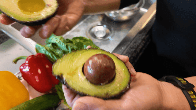 Hands handling fresh avocados