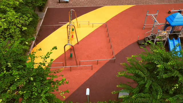 Apartment playground surrounded by trees
