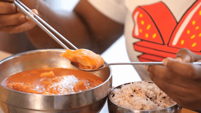 Kimchi jjigae being served with rice