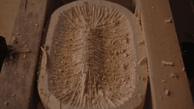 Wood carving process using chisel with intricate patterns
