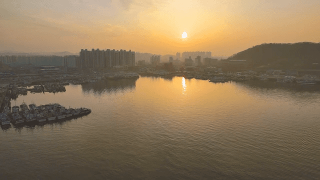 Sunset over a coastal cityscape