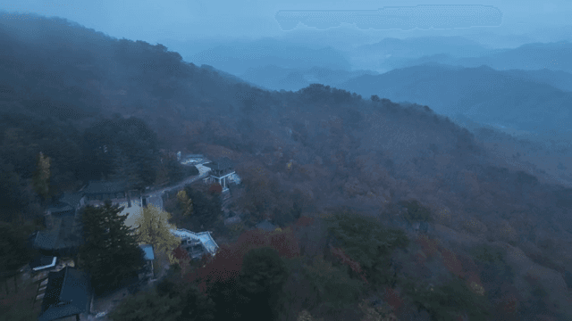 멀리 한옥이 보이는 안개 낀 산 풍경