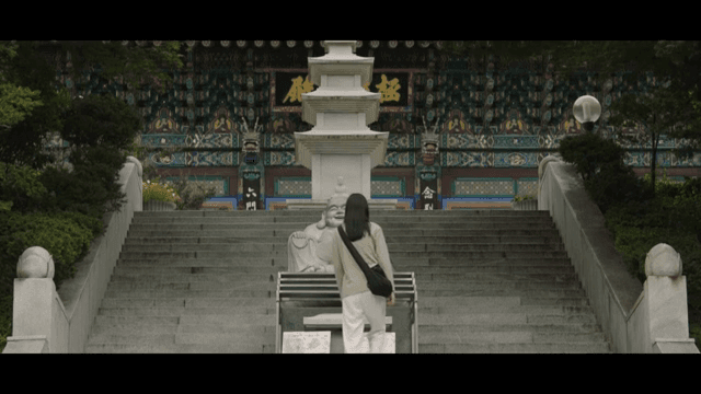 Person approaching a temple statue