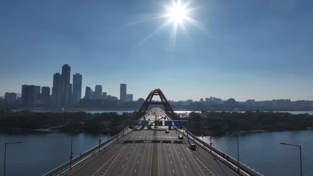 Sunlit Bridge Over Hangang River with Urban Skyline