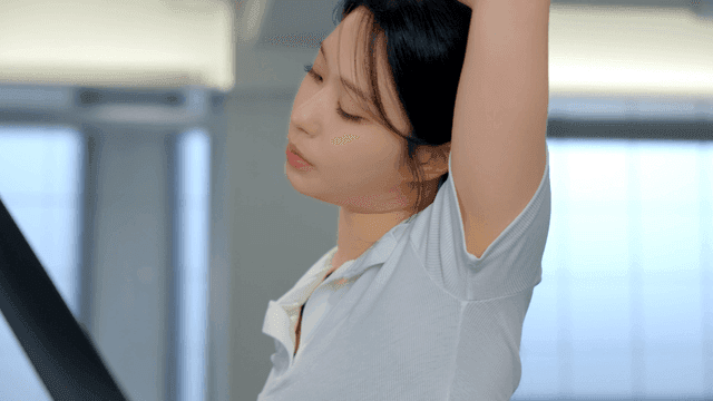Woman stretching on a treadmill at gym