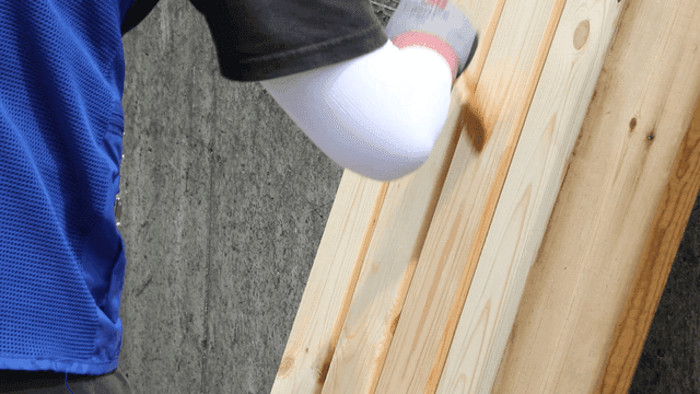 Applying varnish to wooden planks