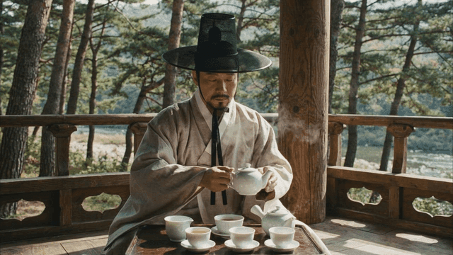 Scholar practicing traditional tea ceremony in wooden pavilion