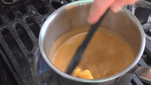 Stirring sauce in a pot on the stove