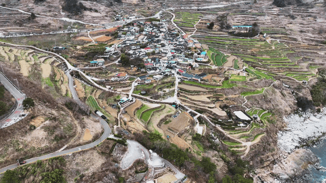 Aerial view of a rural village with terraced fields