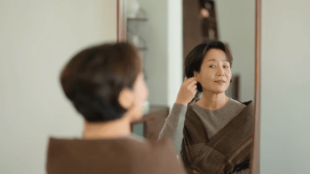 Woman looking at herself in the mirror