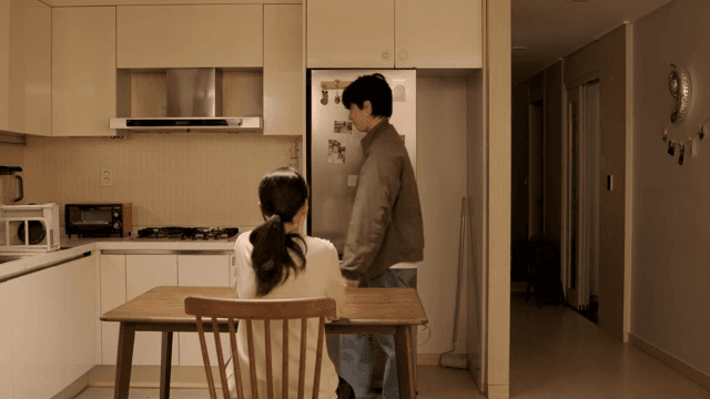 Woman welcoming man in kitchen