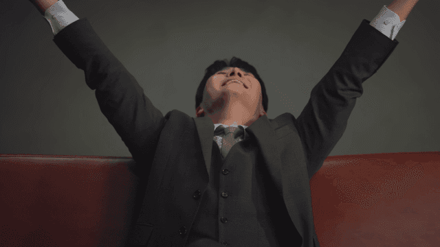 소파에 앉아 돈을 뿌리는 남성