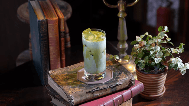 Matcha being poured into iced milk